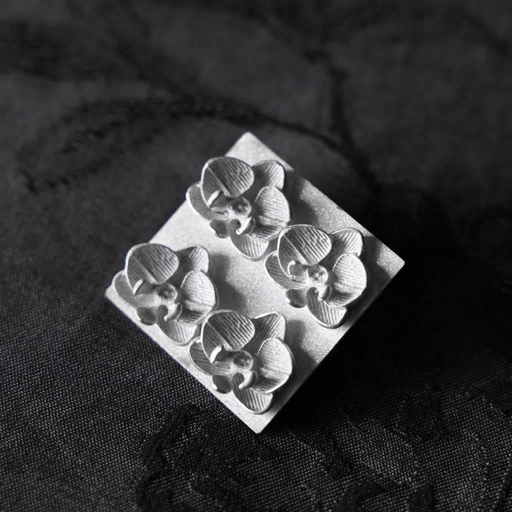 Silver brooch with orchid flowers