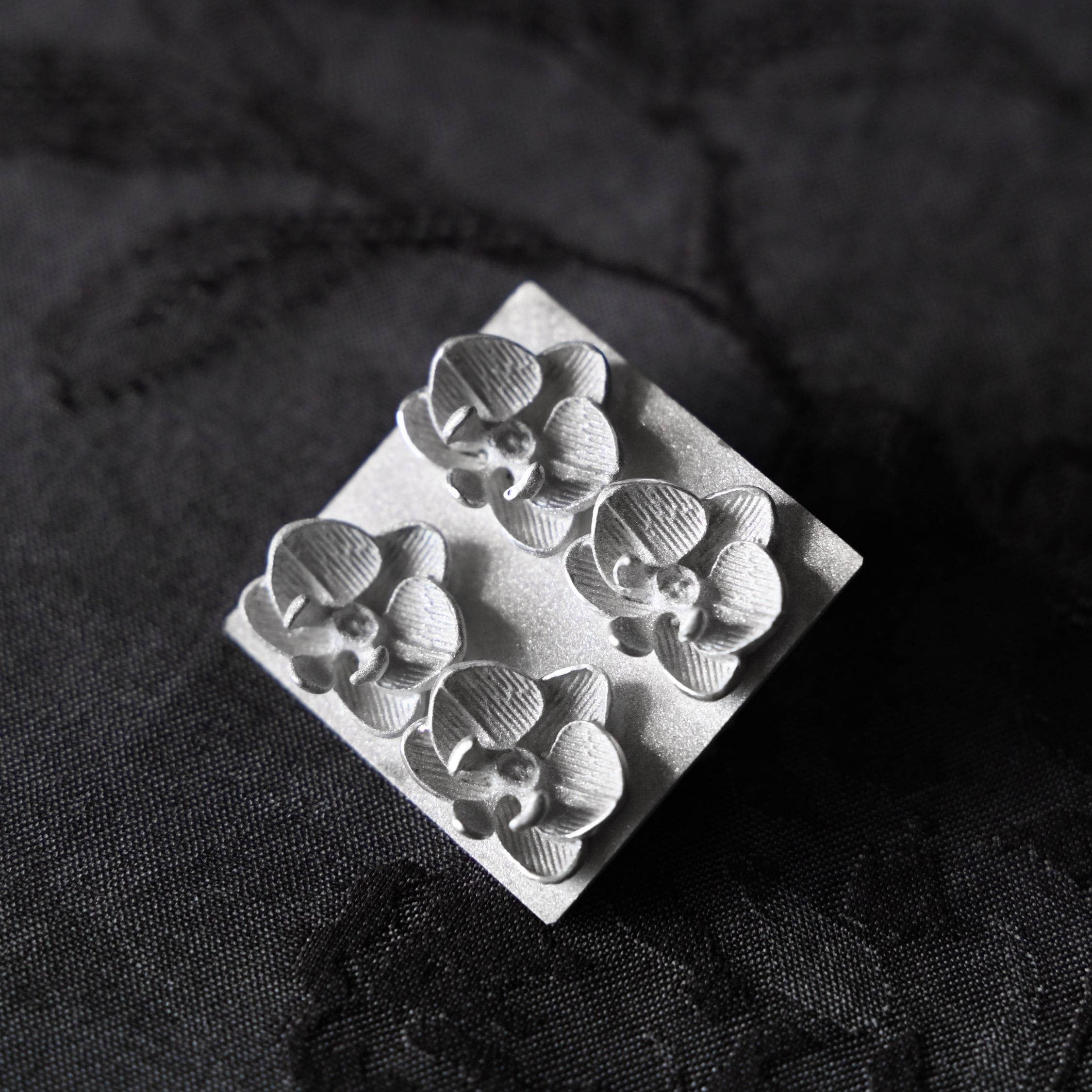 Silver brooch with orchid flowers