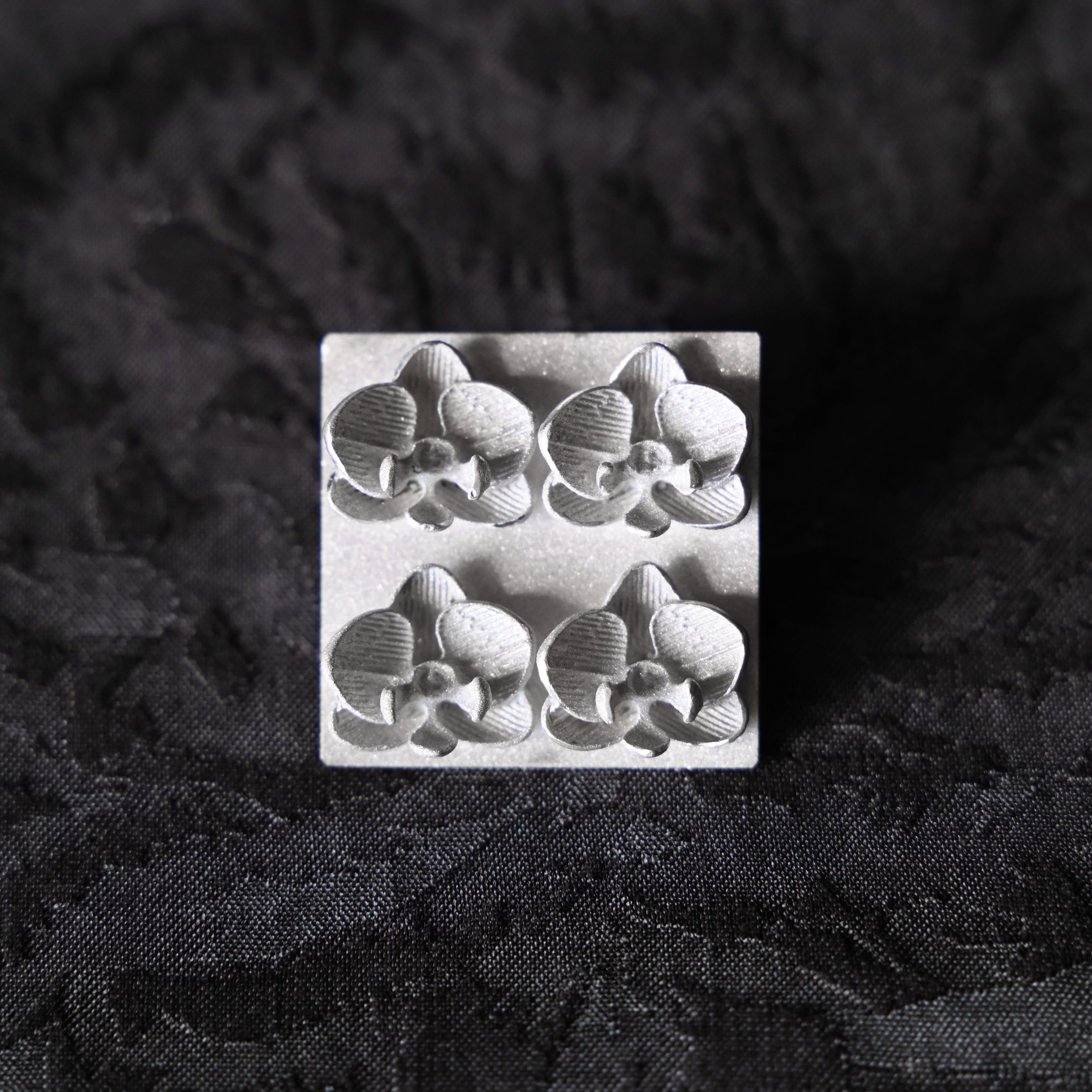 Silver brooch with orchid flowers