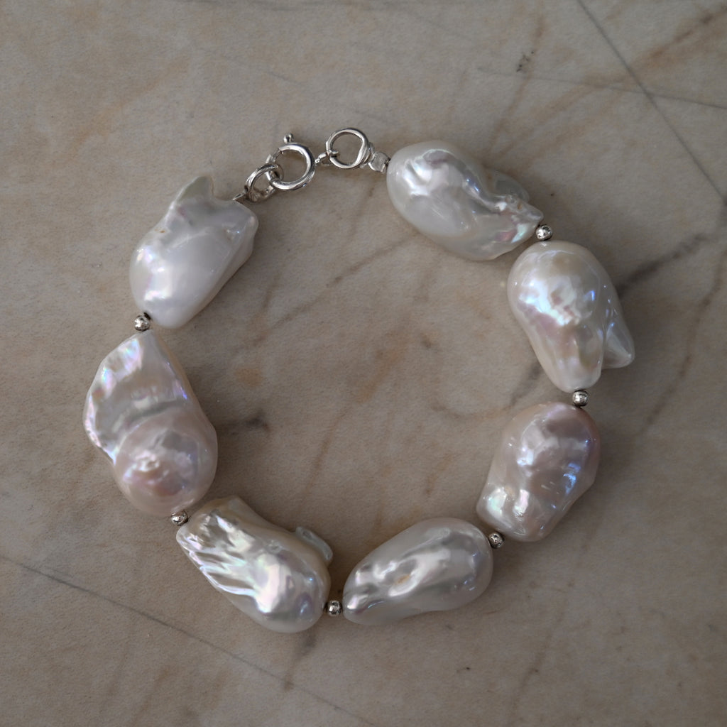Big natural baroque Pearl bracelet on a marble surface
