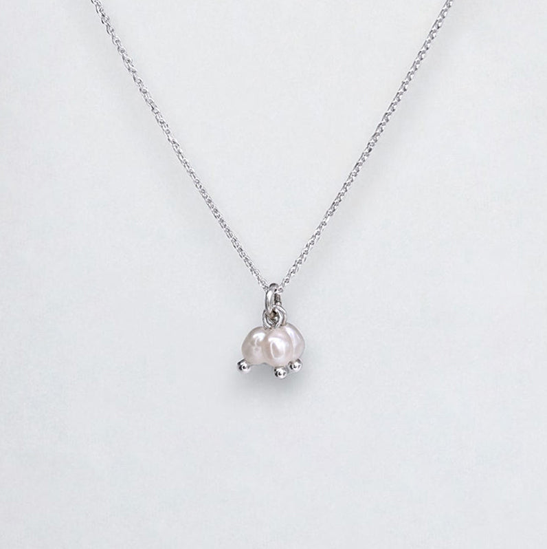 White pearl pendant necklace on a white background