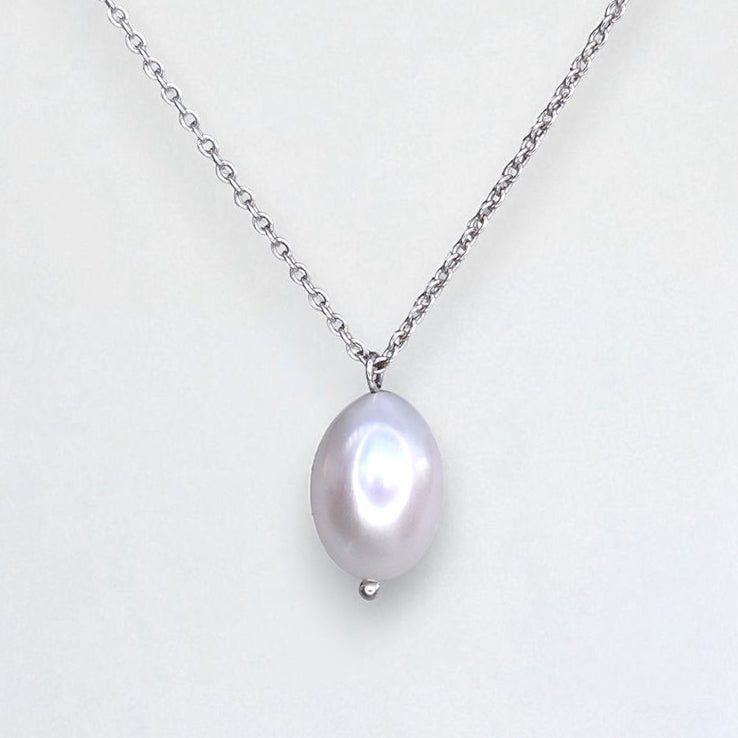Freshwater pearl necklace with silver chain on a white background