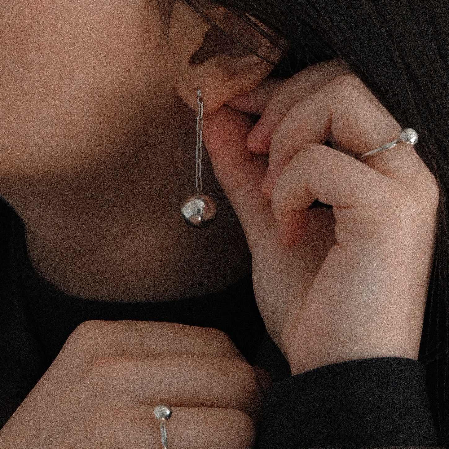 Woman wearing sterling silver long ball earrings