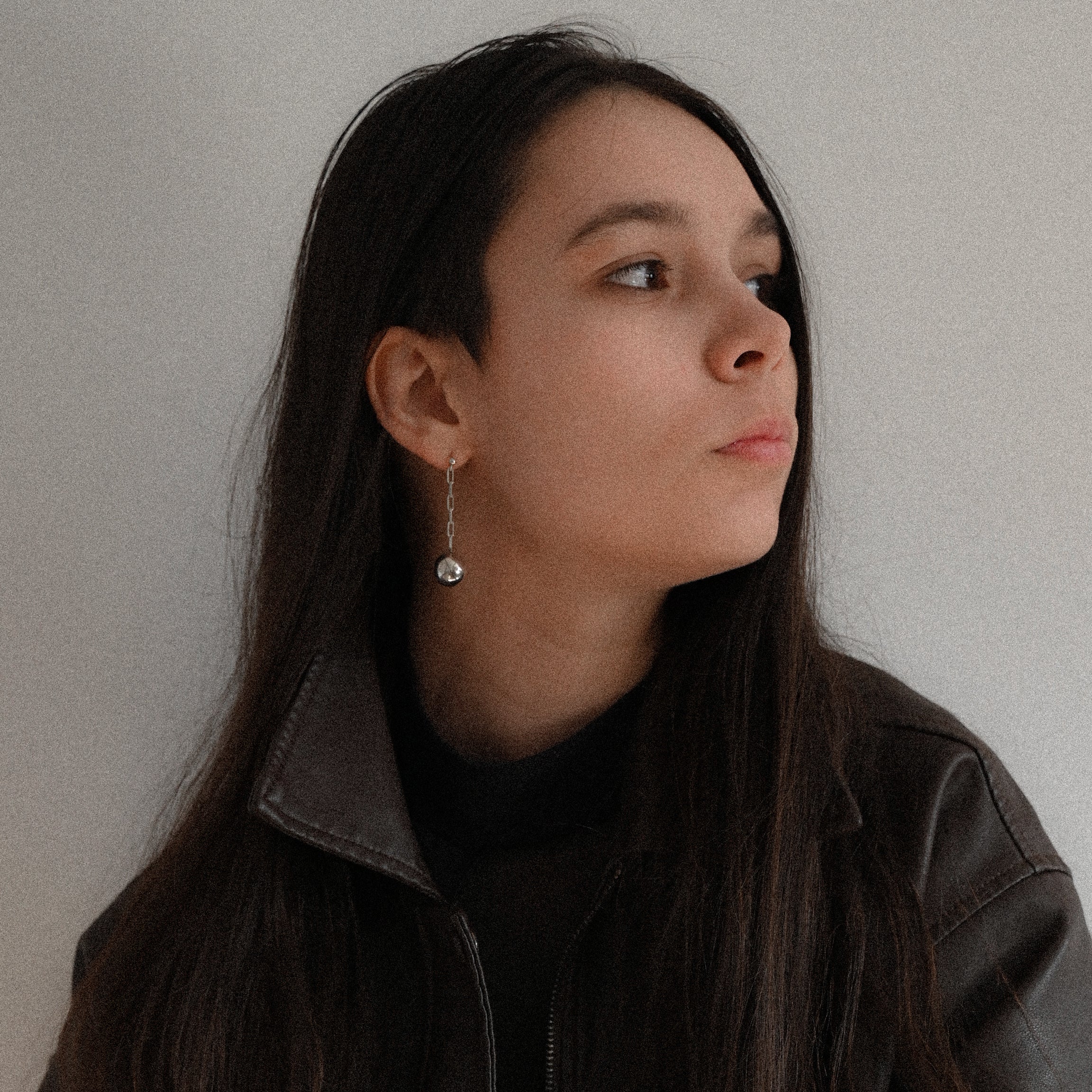 Woman wearing long sterling silver ball chain earrings