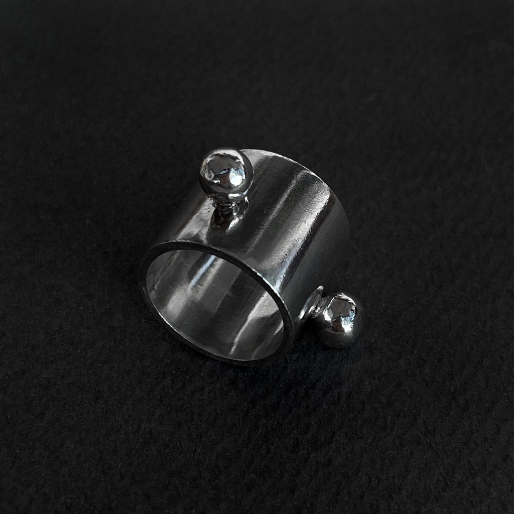 Massive Silver Ring with two spheres on a black background