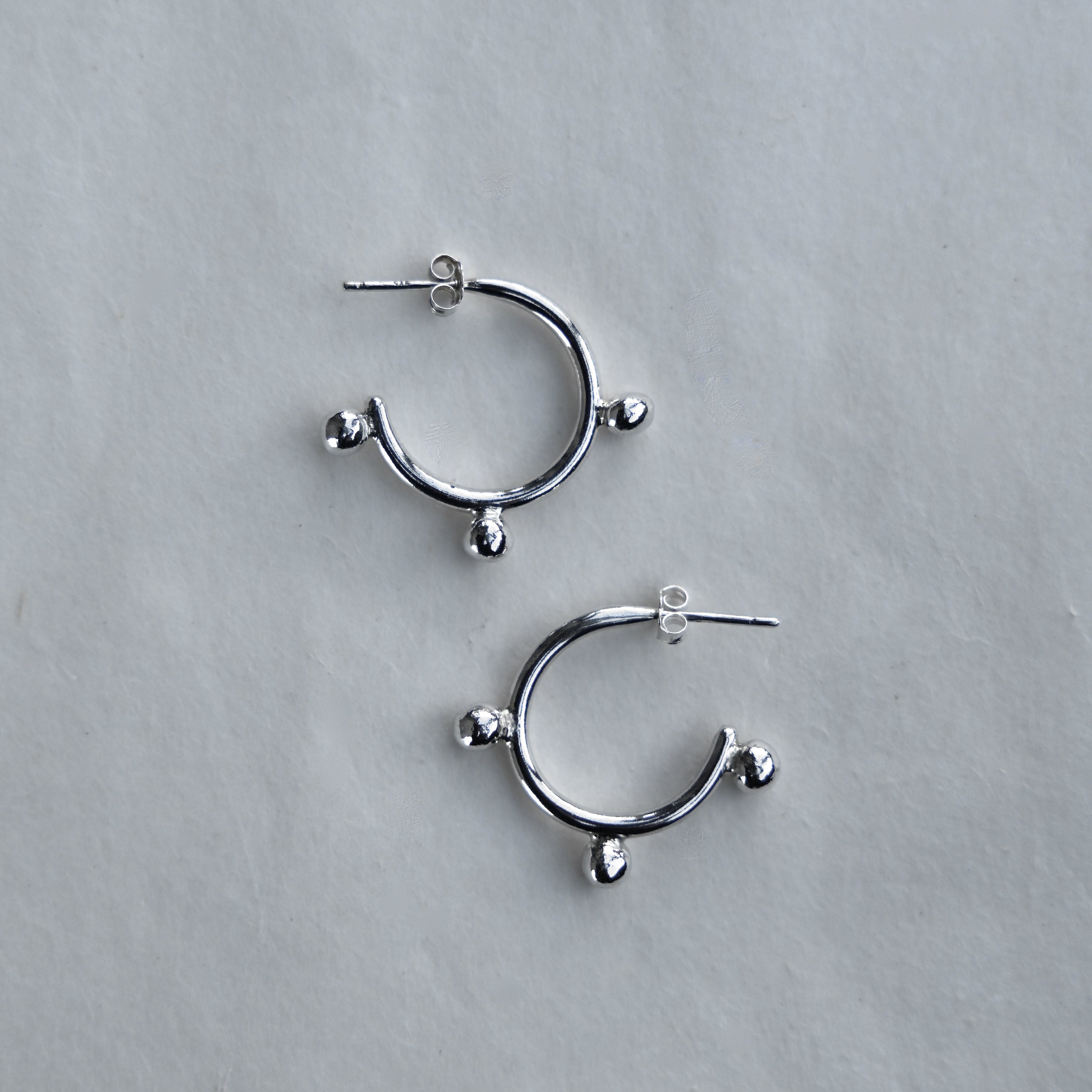 Sterling silver hoop earrings on a white bakground