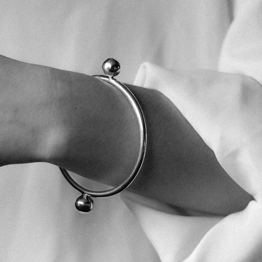 Woman's hand wearing sterling silver bangle